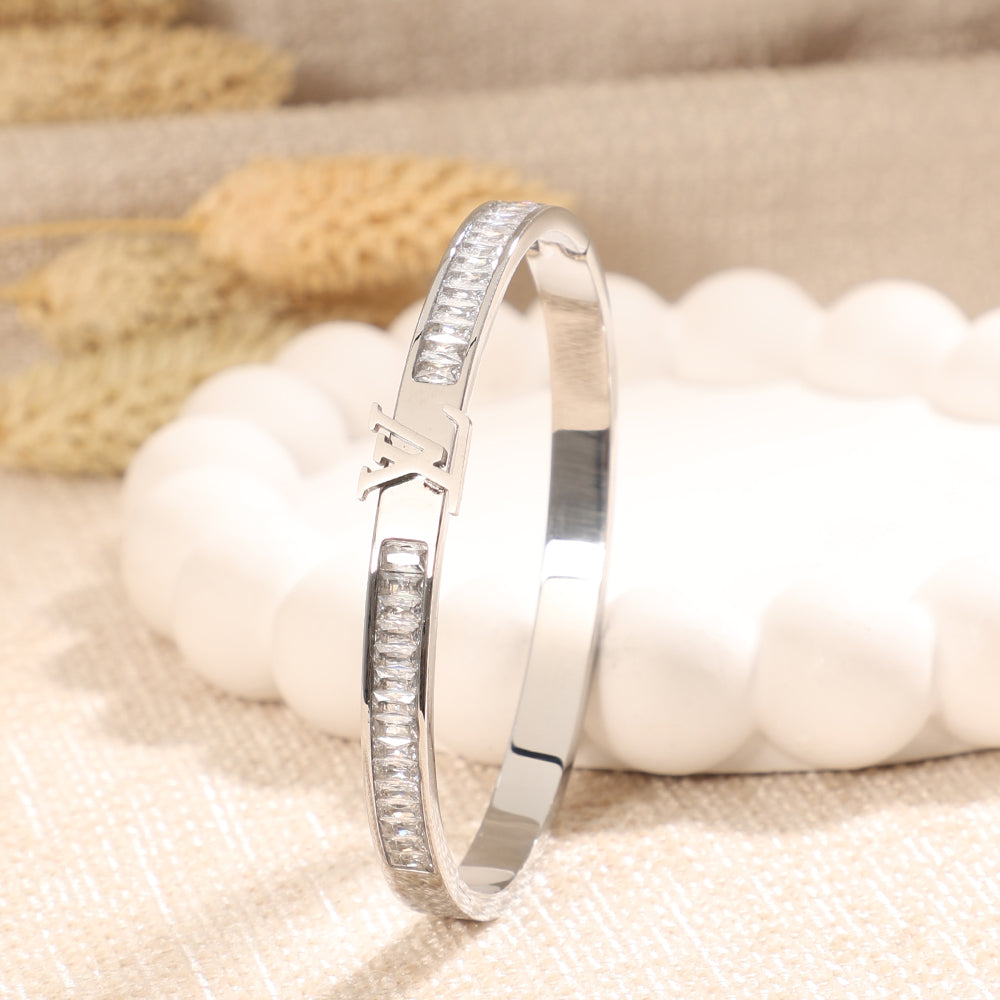 Silver Toned Crystal Baguette Bangle with Logo Accent